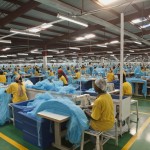 Employees at a textile mill manufacture durable mosquito nets for distribution to high-risk areas for malaria.  (Gates Foundation)